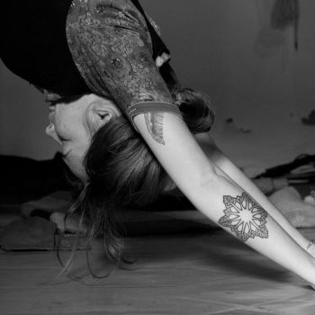 In a black, and white photo, An adult girl performing the Forward bends Yoga pose
