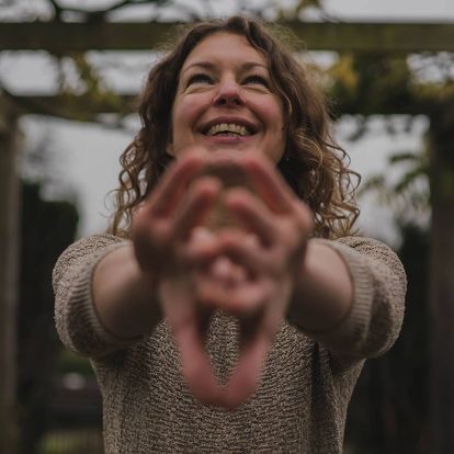 35-year-old woman feeling happiness, with her twisted arms & hand twist