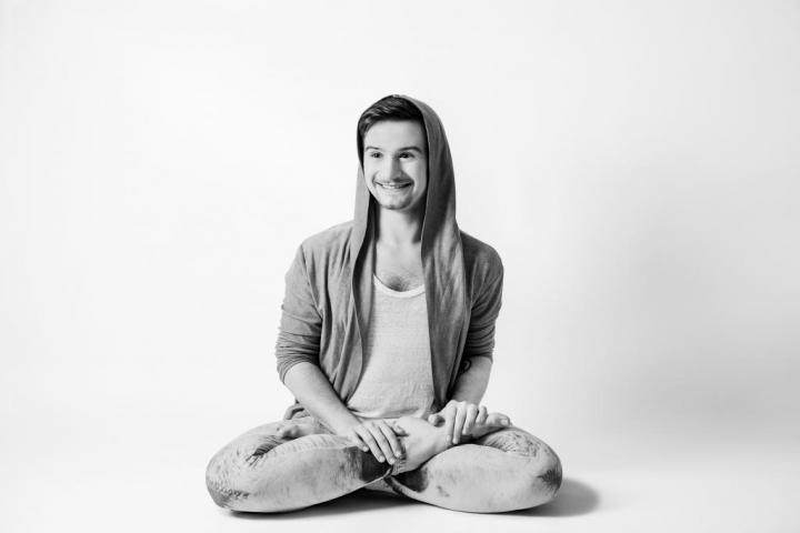 A man sitting with Therapeutic & transformative yoga poses accessible to all