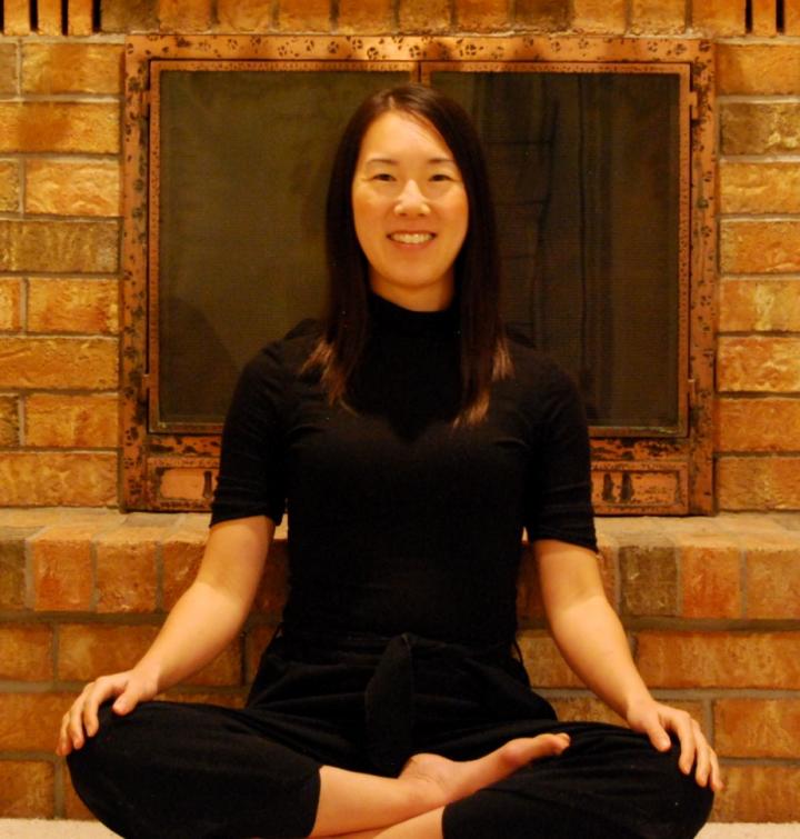 The Chinese adult woman sitting in the massage center with her practicing Pose of Yoga week and leans to the wall