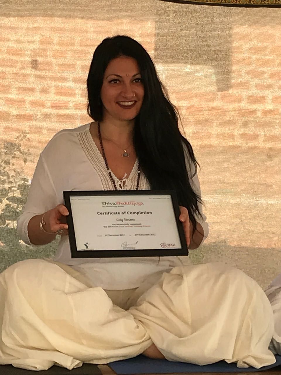 Yoga Nidra student obtaining her awarded the certificate of completion