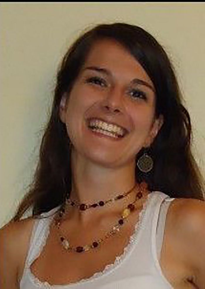 A beautiful young girl smiling awesome, wearing a necklace and white bra