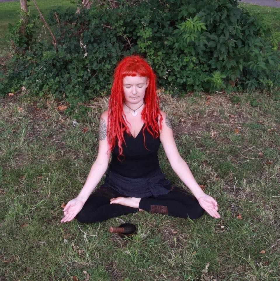 A Woman practicing yoga, with their body, twisted and their arms extended